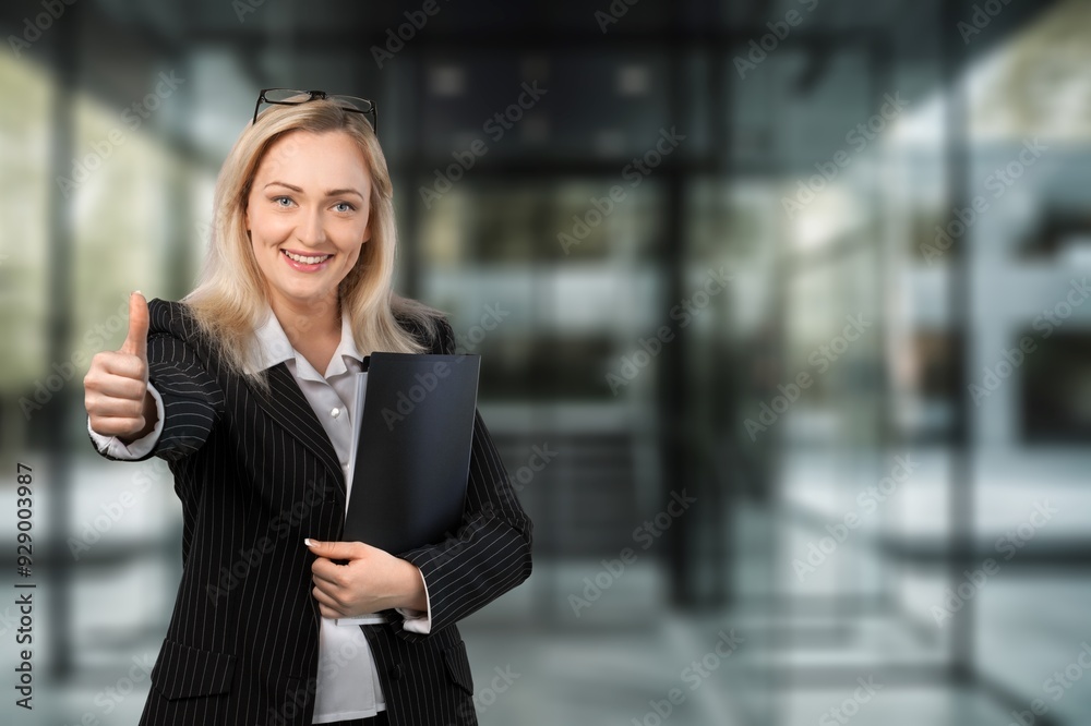 Happy professional business woman posing in office Happy professional business woman posing in office
