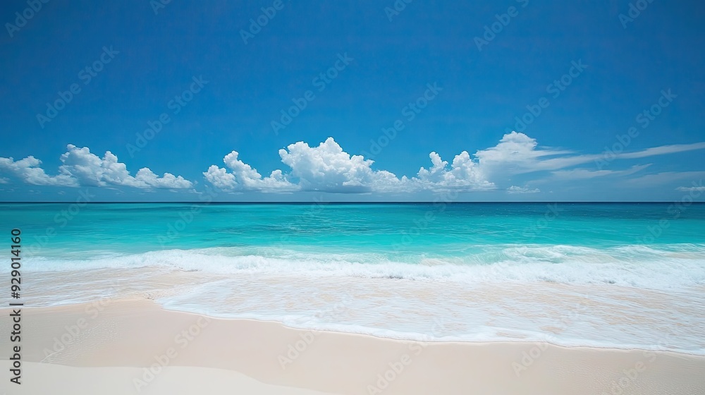 Fototapeta premium Turquoise sea meeting a white sandy beach, with gentle waves and clear skies, perfect for a tranquil Caribbean vacation.