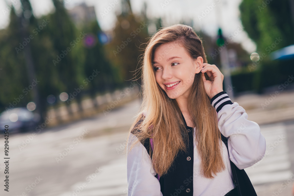 Photo portrait of pretty teen girl look empty space tuck hair behind ear dressed stylish uniform outfit walk outside green park background Photo portrait of pretty teen girl look empty space tuck hair behind ear dressed stylish uniform outfit walk outside green park background