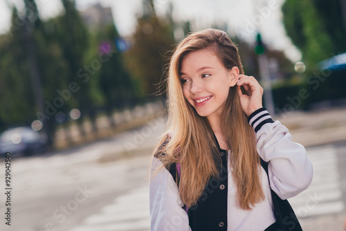Obraz na plátne Photo portrait of pretty teen girl look empty space tuck hair behind ear dressed