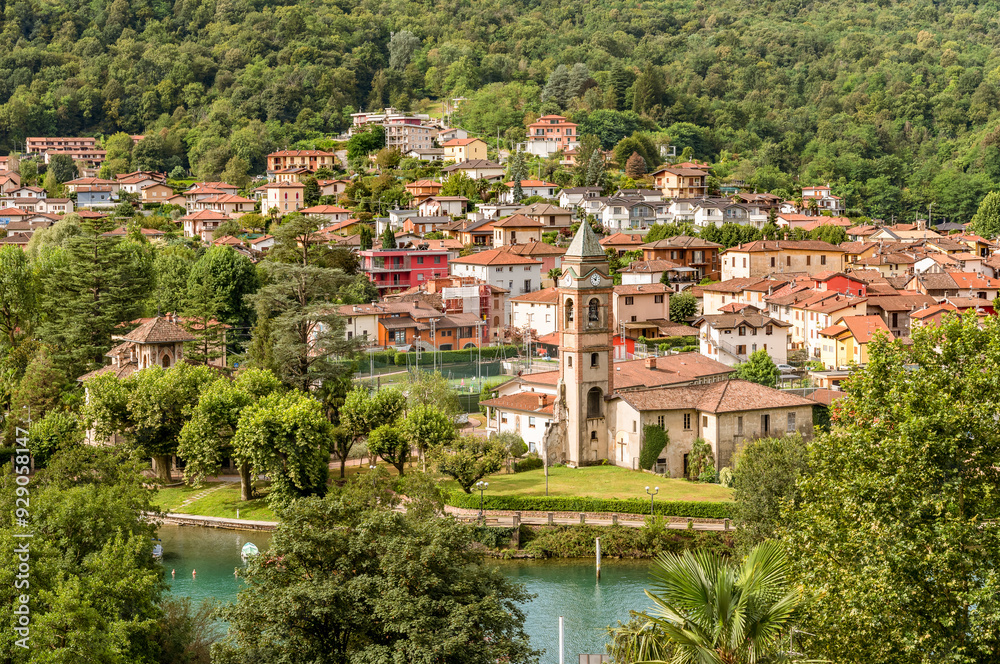 Obraz premium View of the ancient church of Saints Peter and Paul in Lavena Ponte Tresa, overlooks Lake Lugano, province of Varese, Lombardy, Italy