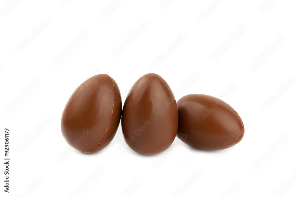 Easter chocolate egg isolated on white background. Easter celebration concept. Happy Easter. Chocolate sweet eggs. Candies on textured wooden table. Space for text.Copy space Easter chocolate egg isolated on white background. Easter celebration concept. Happy Easter. Chocolate sweet eggs. Candies on textured wooden table. Space for text.Copy space