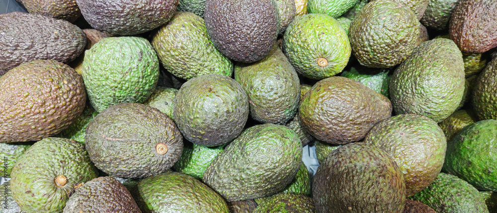 The close-up photo features a ripe avocado, its smooth, dark green skin contrasting with the creamy, vibrant interior. The fruit's rich texture and color highlight its abundance of vitamins and nutrie The close-up photo features a ripe avocado, its smooth, dark green skin contrasting with the creamy, vibrant interior. The fruit's rich texture and color highlight its abundance of vitamins and nutrie