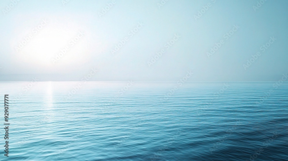 Obraz premium Tranquil Sea Horizon: A serene and calming image of a vast ocean at sunrise or sunset, with the sun shining brightly in the distance. 