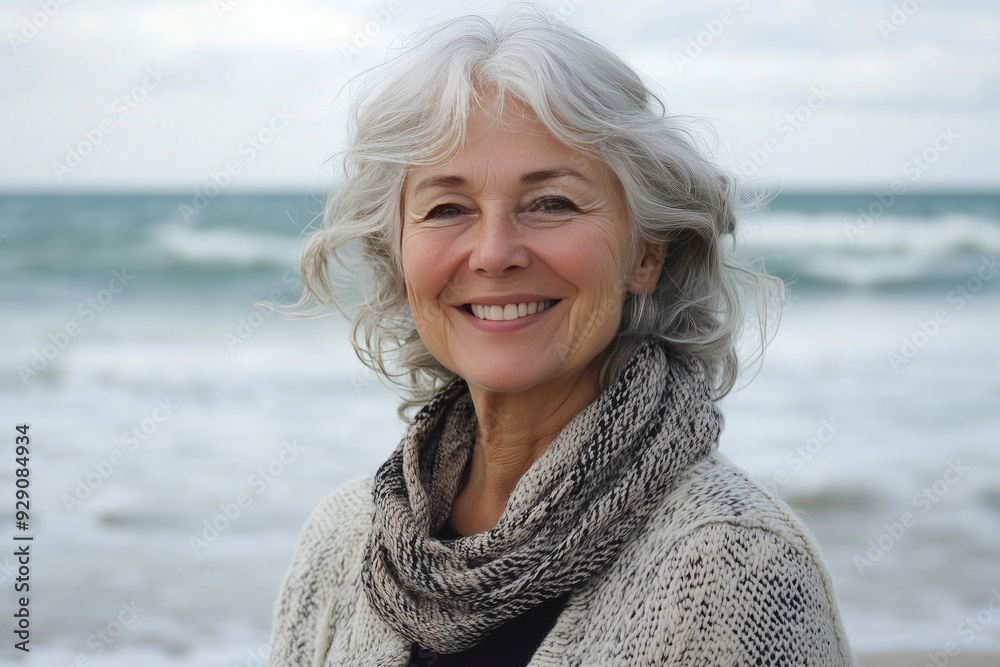 Happy elderly woman standing by the ocean Happy elderly woman standing by the ocean