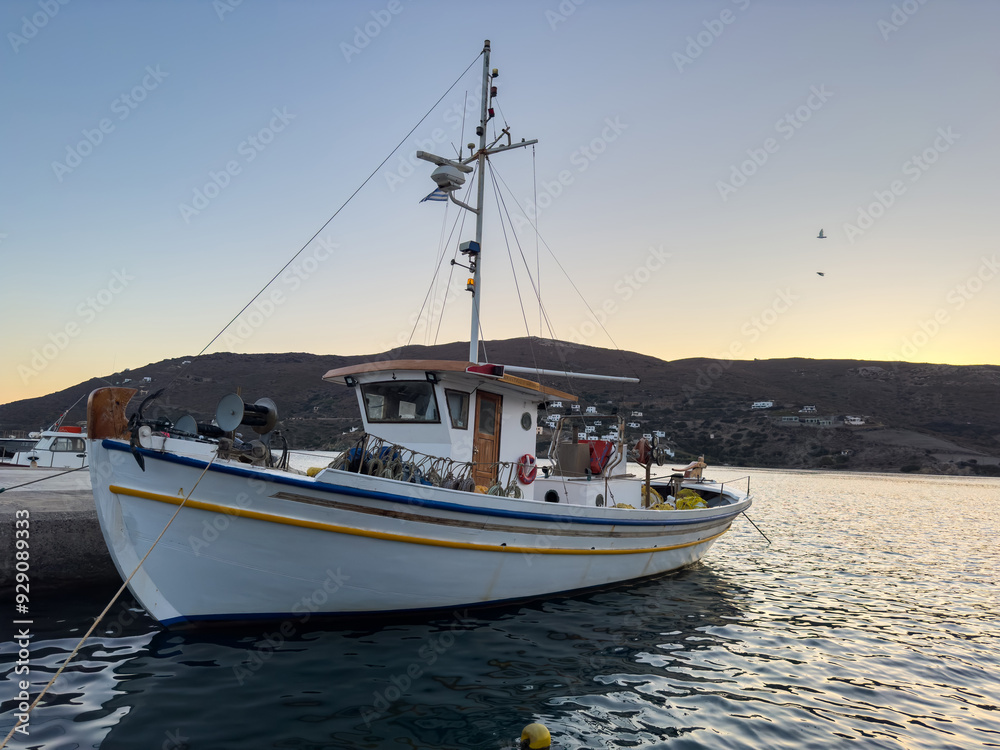 Andros island, Cyclades Greece. Wooden boat moored at Gavrio port Andros island, Cyclades Greece. Wooden boat moored at Gavrio port