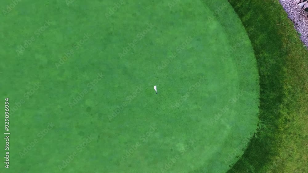 Video of a close view of a golf hole that quickly zooms back and up. Great for adding text, logos, vfx.