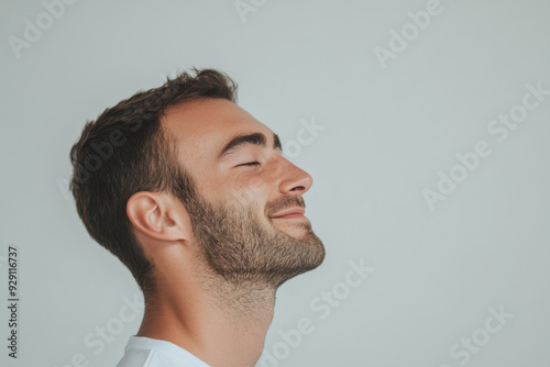 A close up of a man's face with his eyes closed