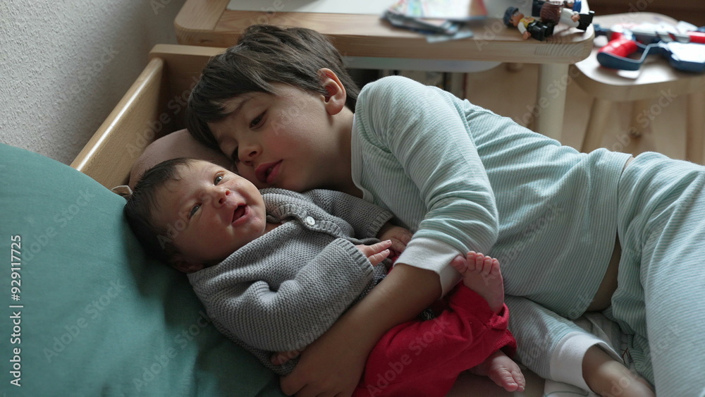Older sibling lies beside a newborn baby, sharing a tender moment of affection and bonding, showcasing the love and connection between siblings in a cozy home setting Older sibling lies beside a newborn baby, sharing a tender moment of affection and bonding, showcasing the love and connection between siblings in a cozy home setting