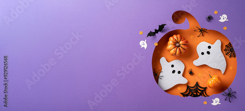 Creative Halloween composition featuring a pumpkin, ghosts, bats, and spiders on a vibrant background. Ideal for seasonal celebrations and festive advertising photo