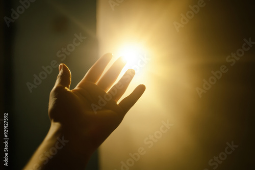 Person is reaching for a light, symbolizing hope and escape from a difficult situation