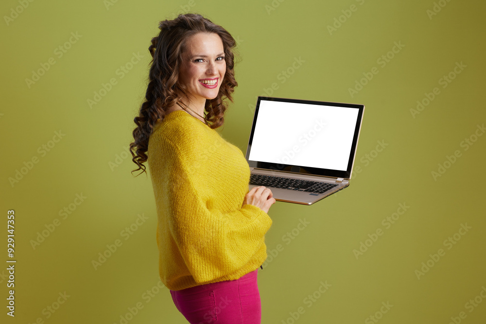 smiling woman showing laptop blank screen isolated on green smiling woman showing laptop blank screen isolated on green