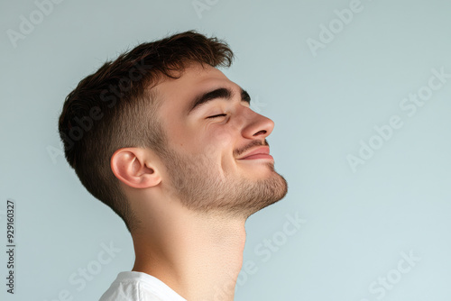 A close up of a man's face with his eyes closed