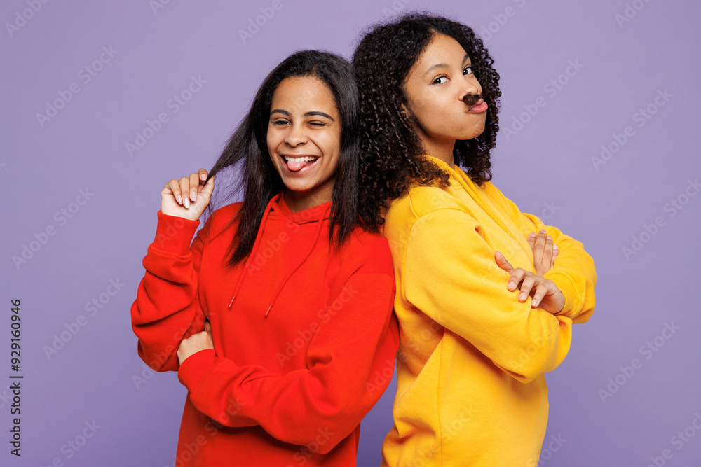 Two young little kid teen girls women they wear red yellow hoodie casual clothes hold play with hair pov mustache show tongue wink isolated on plain pastel light purple background. Lifestyle concept. Two young little kid teen girls women they wear red yellow hoodie casual clothes hold play with hair pov mustache show tongue wink isolated on plain pastel light purple background. Lifestyle concept.