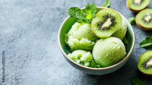 Refreshing kiwi sorbet served in a bowl with fresh mint leaves, perfect for a summer treat.