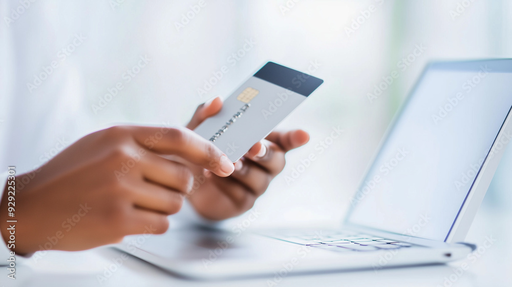 A person using a smartphone for online shopping, holding a credit card to make a secure transaction. The close-up shot highlights the convenience and security of mobile payments, m A person using a smartphone for online shopping, holding a credit card to make a secure transaction. The close-up shot highlights the convenience and security of mobile payments, m