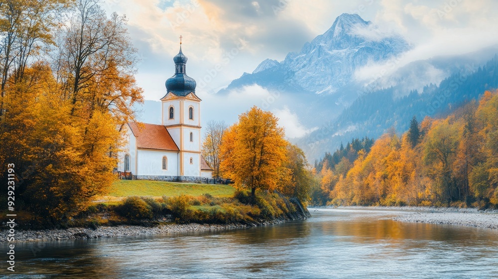 Fototapeta premium Gorgeous scenery found in nature. Amazing view in October. Beautiful mountain scenery found in the Bavarian Alps. quaint little church beside the river.viewpoint of the well-known St. Sebastian Parish