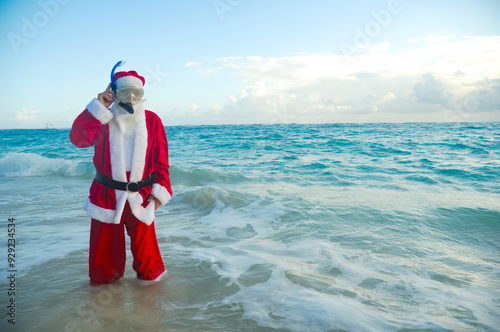 Santa Claus is on vacation on a tropical beach.