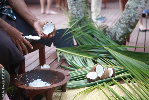 Scraping fresh coconut, traditional food demonstration, Fiji photo