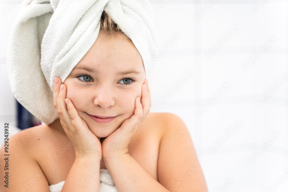 Portrait of a little pre-teenage girl in the mirror in a white bathroom, with a towel on her head. Portrait of a little pre-teenage girl in the mirror in a white bathroom, with a towel on her head.