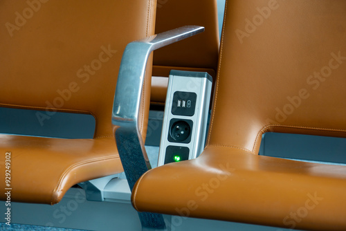  Battery charger power socket for cell phone between seats in waiting lounge at the airport. Free cell phone charging facility