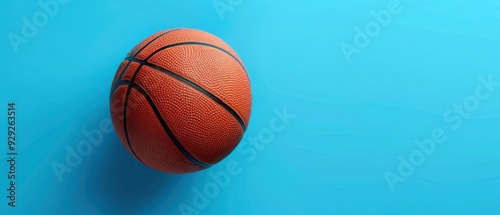 Basketball on a blue background with space for text. Free copy space for text.