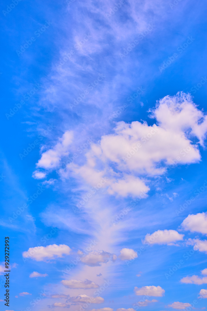 Wispy Clouds in Vibrant Blue Sky from Eye-Level Perspective Wispy Clouds in Vibrant Blue Sky from Eye-Level Perspective