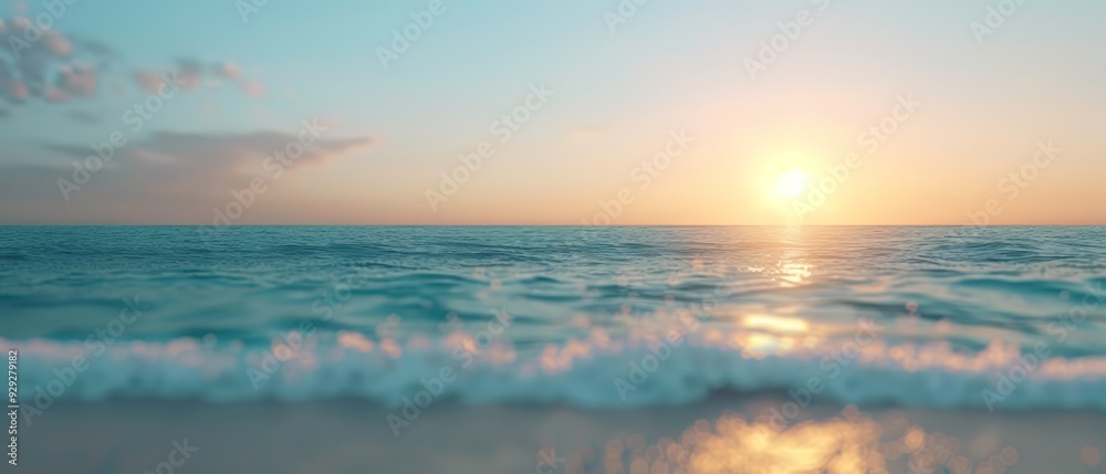 Fototapeta premium The sun sets over the ocean, with a wave in the foreground and a beach visible beyond