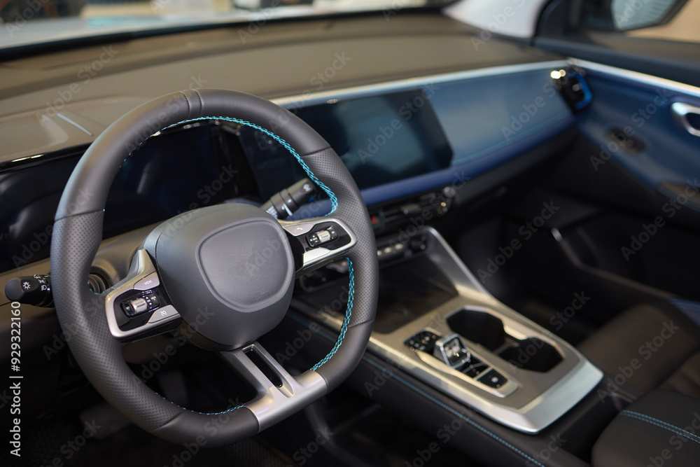 Closeup of a modern car steering wheel with control buttons for technology and convenience Closeup of a modern car steering wheel with control buttons for technology and convenience