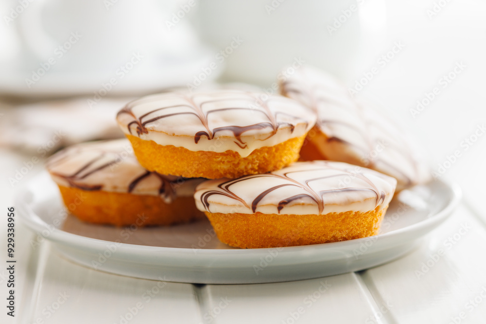 Sweet dessert with sugar coating on plate on white table. Sweet dessert with sugar coating on plate on white table.