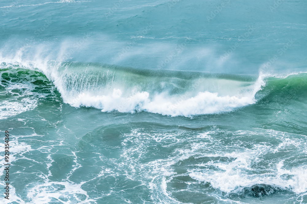 Fototapeta premium Wave splashing close-up. Crystal clear sea water, in the ocean in San Francisco Bay, blue water, pastel colors.