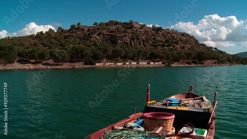 anchored fishing boat and ancient Greek city, Kiyikislacik, Milas Mugla photo