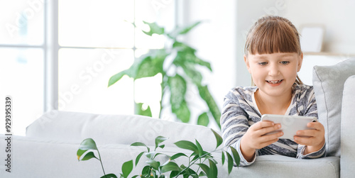 Little girl with mobile pho...