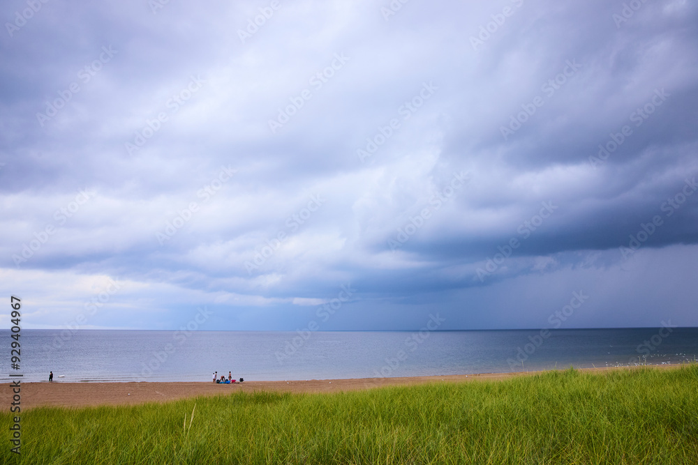 Tranquil Stormy Beach Scene with People Near Lake Michigan Eye-Level Perspective Tranquil Stormy Beach Scene with People Near Lake Michigan Eye-Level Perspective