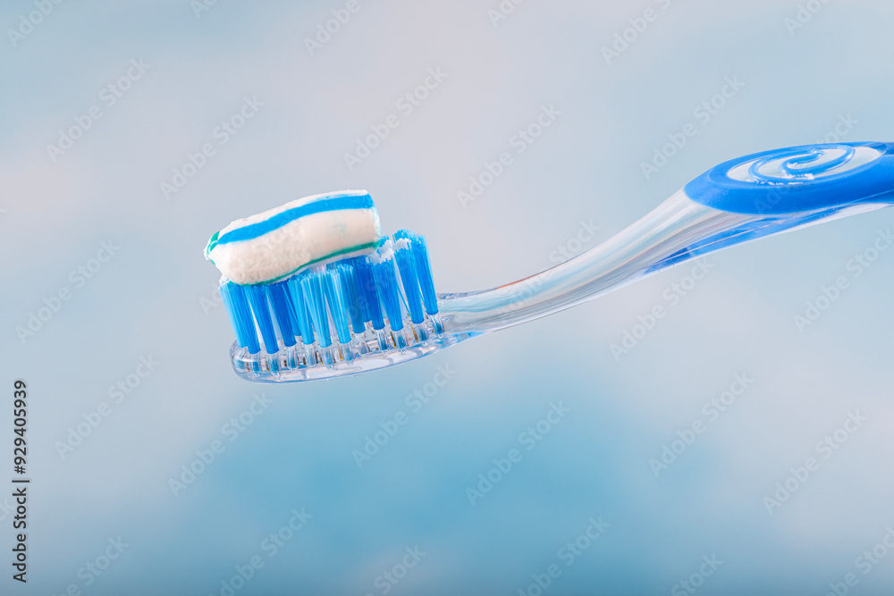Toothbrush and toothpaste, Squeezing toothpaste onto toothbrush. Applying toothpaste on brush against blurred background, closeup. Toothbrush and toothpaste, Squeezing toothpaste onto toothbrush. Applying toothpaste on brush against blurred background, closeup.