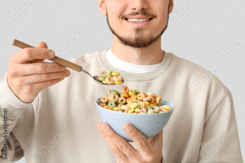 Man holding bowl and spoon ...