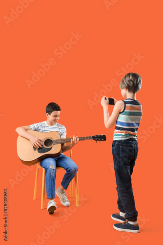 Little boy recording his br...