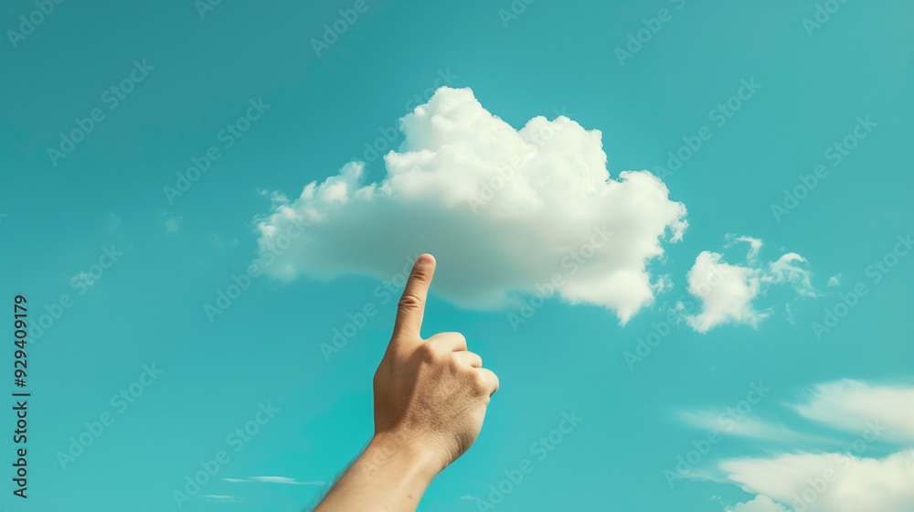 Hand pointing towards a fluffy white cloud in a clear blue sky, evoking a sense of wonder and imagination. Hand pointing towards a fluffy white cloud in a clear blue sky, evoking a sense of wonder and imagination.