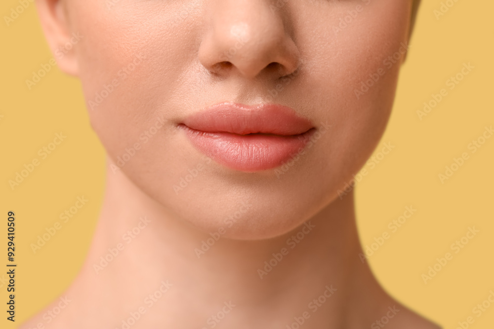 Young woman with beautiful lips on yellow background, closeup Young woman with beautiful lips on yellow background, closeup