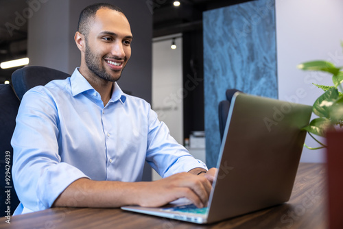 African American man digital entrepreneur working on e-commerce startup project on laptop