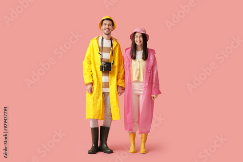 Young couple in raincoats o...
