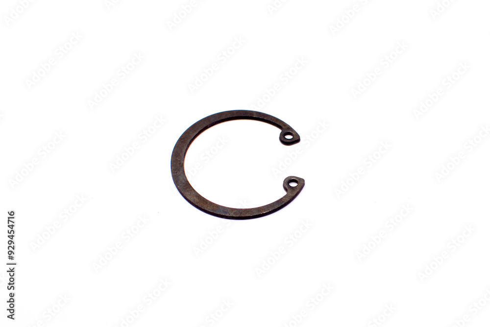 Black circlip retaining rings scattered on a white background. Black circlip retaining rings scattered on a white background.