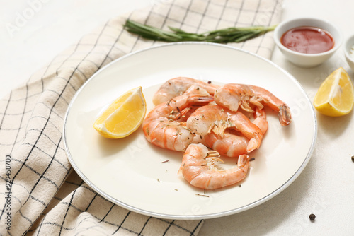 Plate with tasty boiled shrimps, lemon and rosemary on white background