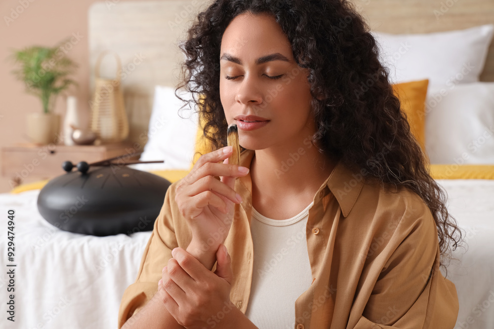 Young African-American woman with Palo Santo in bedroom, closeup Young African-American woman with Palo Santo in bedroom, closeup