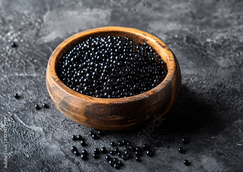 Caspian sea caviar with fine black pearls presented on a sophisticated dish, showcasing texture and elegance, professional food photography, close-up view composition.

 photo