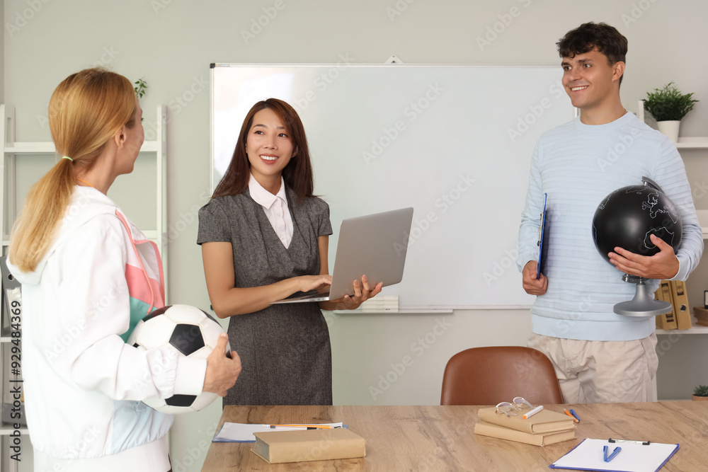 Teachers working in school office Teachers working in school office