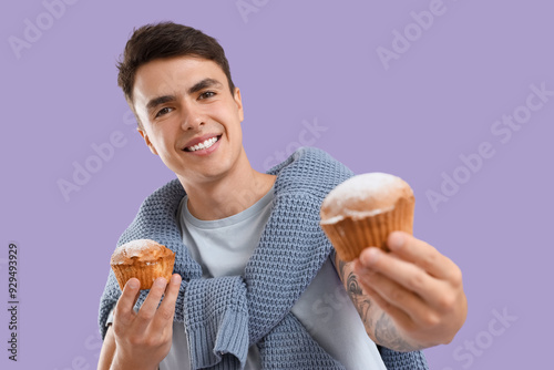 Young man with tasty muffin...