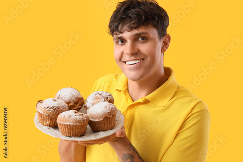 Young man with tasty muffin...