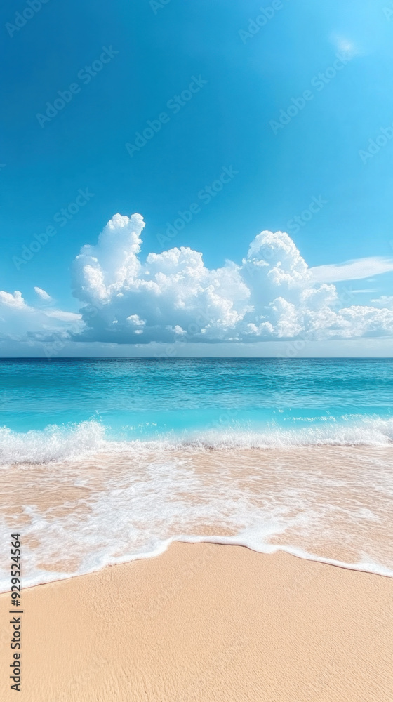 A beautiful beach with a blue sky and a few clouds. The ocean is calm and the waves are small A beautiful beach with a blue sky and a few clouds. The ocean is calm and the waves are small