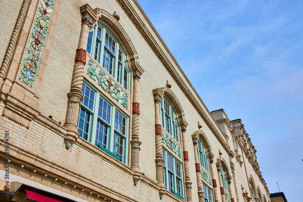 Obraz premium Ornate Historical Facade with Arched Windows from Low Angle